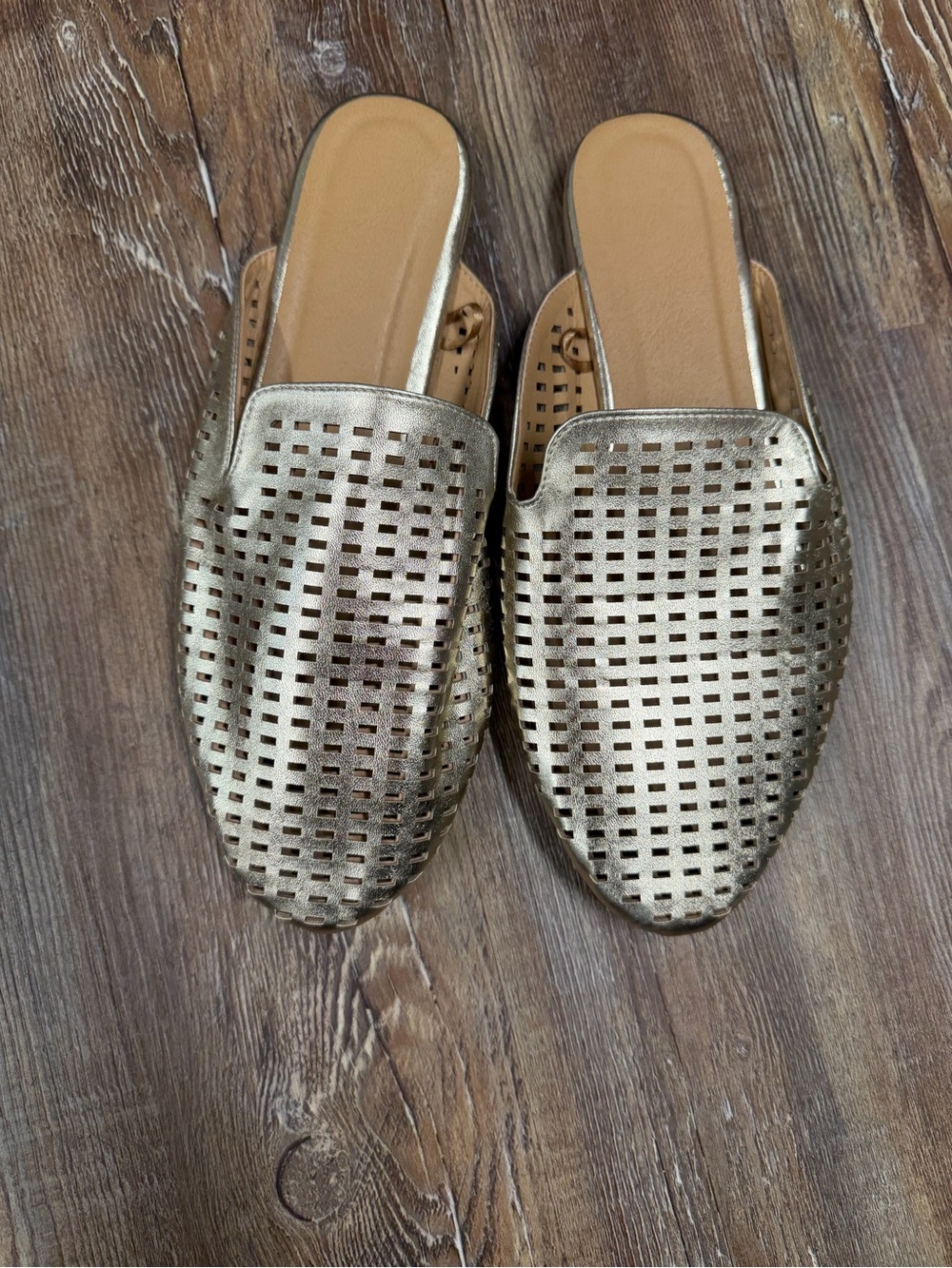 Gold metallic leather mules with perforated grid pattern